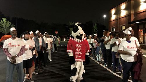 The 100 winners of Chick-fil-A meals for a year lined up with the Chick-fil-A mascot early on April 27 to receive their prize. Photo: Ligaya Figueras