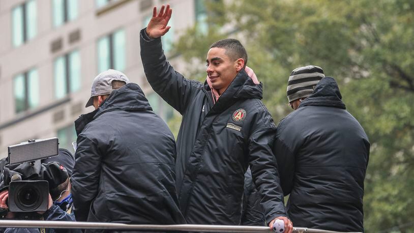 Miguel Almiron waves to the crowds who took to the streets of downtown Atlanta Monday in celebration of Atlanta United's MLS Cup championship. (John Spink/jspink@ajc.com)