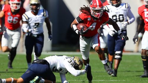 Georgia running back James Cook breaks off a 40-yard run against Charleston Southern during the first quarter Saturday, Nov. 20, 2021, in Athens.  (Curtis Compton / Curtis.Compton@ajc.com)