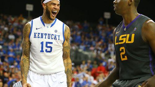 Kentucky forward Willie Cauley-Stein celebrate a slam over LSU forward Jordan Mickey while LSU forward Johnny O'Bryant III looks during the second half of an 85-67 Kentucky win over the Tigers in their SEC quarterfinals matchup Saturday, March 15, 2014, at the Georgia Dome in Atlanta.
