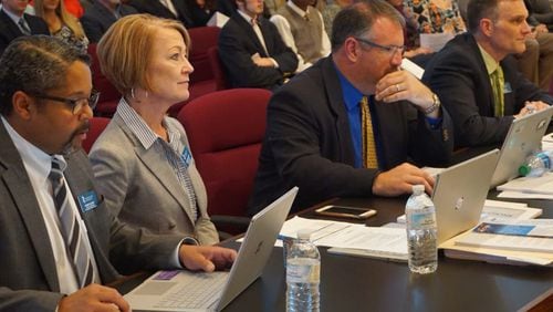 Retiring Assistant Superintendent for Educational Programs Susan McCarthy listens at a recent Cherokee County School Board meeting as she is praised by Superintendent of Schools Brian V. Hightower for her lifetime of service to public education. CHEROKEE COUNTY SCHOOLS