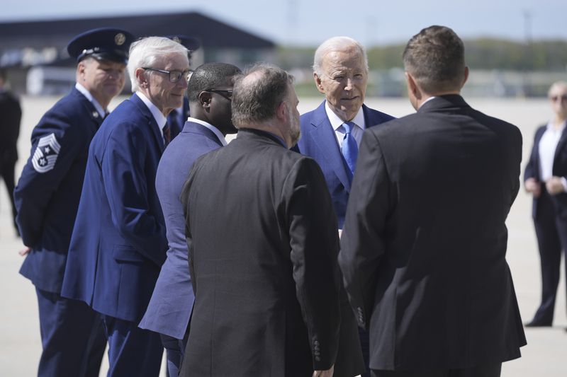 President Joe Biden greets local officials as he arrives at Milwaukee Mitchell International Airport, Wednesday, May 8, 2024, in Milwaukee. (AP Photo/Evan Vucci)