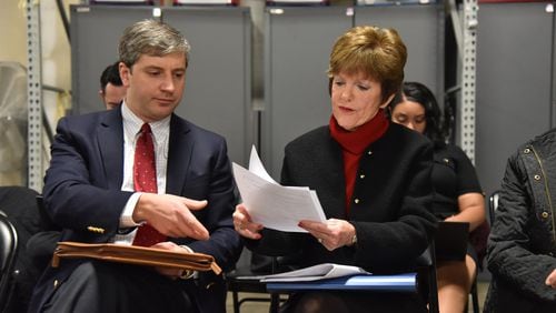 Former mayoral candidate Mary Norwood and her lawyer Vincent Russo (left) confer as they review the recount result at the Fulton County Elections Preparation Center on Dec. 14. HYOSUB SHIN / HSHIN@AJC.COM