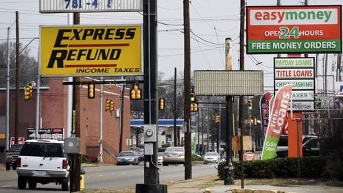 Signs advertise short-term loans in Birmingham, Alabama, in 2015. The Georgia Supreme Court ruled Monday that out-of-state lenders are subject to the state’s prohibitions against high-cost payday loans. Photo: Gary Tramontina/BLOOMBERG
