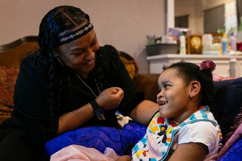 Rhonda Jones smiles at daughter Alayna Hike at their home in Crown Point, Indiana, which is southeast of Chicago. Alayna was injured during her birth and has cerebral palsy. (Taylor Glascock for KHN)