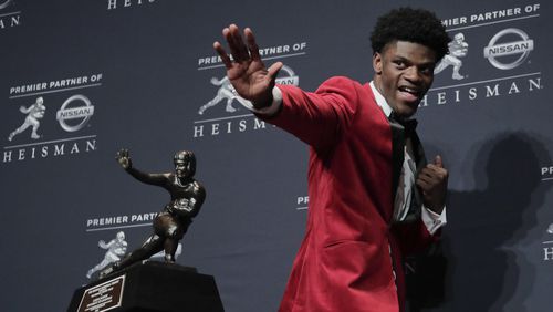 Louisville's Lamar Jackson poses with the Heisman Trophy after winning the Heisman Trophy award, Saturday, Dec. 10, 2016, in New York. (AP Photo/Julie Jacobson)