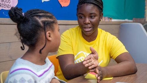 Kimberly Heard (right) helps 8-year-old Brooklyn DeBerry with homework at the A.R. “Gus” Barksdale Boys & Girls Club in Conyers. She was given the Boys & Girls Clubs of Metro Atlanta’s most prestigious award - 2019/2020 Youth of the Year. She advocates for underserved teens and helps them overcome obstacles. (Photo by Phil Skinner)