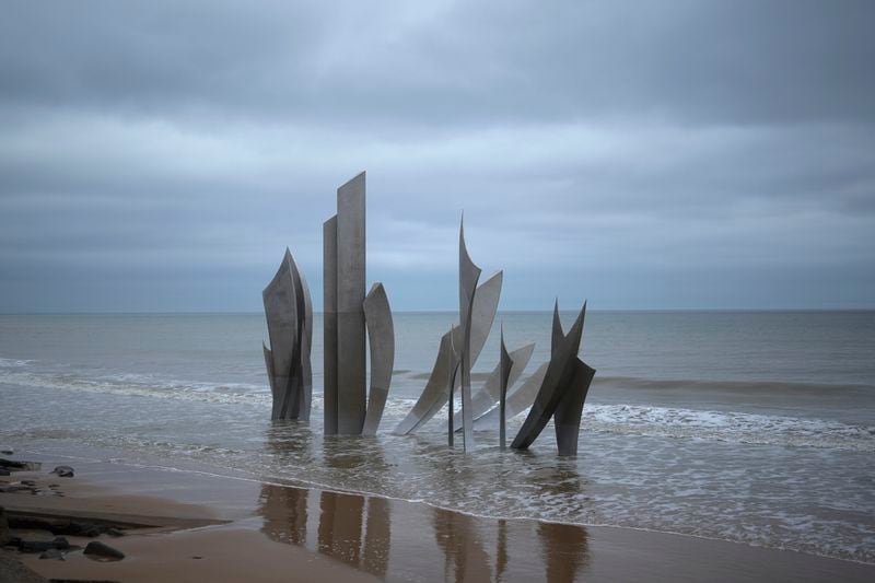The monument called Les Braves, dedicated to the American soldiers who landed on Omaha Beach on D-Day, is seen on Omaha Beach at sunset, in Saint-Laurent-sur-Mer, Normandy, Thursday, April 11, 2024. On D-Day, Charles Shay was a 19-year-old Native American army medic who was ready to give his life — and actually saved many. Now 99, he's spreading a message of peace with tireless dedication as he's about to take part in the 80th celebrations of the landings in Normandy that led to the liberation of France and Europe from Nazi Germany occupation. (AP Photo/Thibault Camus)