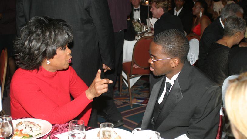 Oprah Winfrey paid for Tope Folarin's senior year at Morehouse College when his scholarship disappeared.. Here the two sit together at an appreciation dinner. Photo: Philip McCollum
