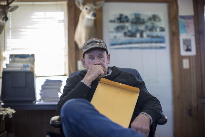 Bulloch County farmer Ray Davis sits in his farm office with documents that map out well sites on Wednesday, Feb. 21, 2024 near Brooklet, Ga. (AJC Photo/Stephen B. Morton)
