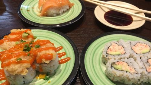 The Spicy Popcorn Shrimp Roll and the Real Crab California Roll are among the options at Kula Revolving Sushi Bar in Doraville. In the back is the Garlic Ponzu Salmon Nigiri. CONTRIBUTED BY WENDELL BROCK