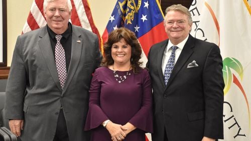 Peachtree City council members Terry Ernst (left) and Kevin Madden (right) were sworn into office along with re-elected Mayor Vanessa Fleisch. Jill Howard Church for the AJC