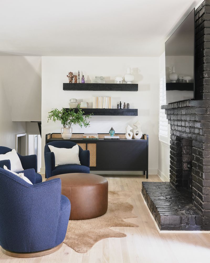 Dramatic black salvaged mantels work with smaller collectibles — bought on the homeowners' travels — here because of the striking contrast of large and small scales, designer Andi Morse says.
(Courtesy of Morse Design / Elliot Fuerniss Photography)