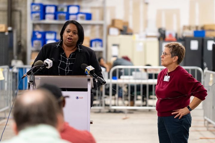 Nadine Williams, interim director of registration and elections for Fulton County, briefs journalists just after the close of polls Tuesday, Dec. 6, 2022, as board chair Cathy Woolard listens.  Ben Gray for the Atlanta Journal-Constitution