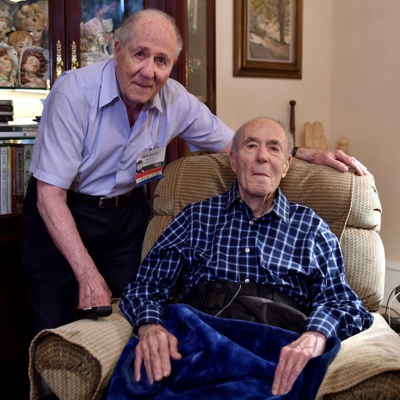 Hilbert Margol (left) and his twin brother Howard (now deceased) on August 20, 2015, in Marietta. The twins served together in World War II. (BRANT SANDERLIN / AJC file photo)