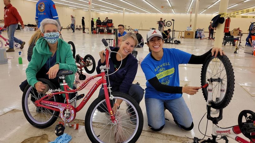 Last year, volunteers with Bikes For Kids donated used bicycles and cleaned and prepared them for North Fulton Community Charities Toyland gift market. Courtesy of Bike Alpharetta