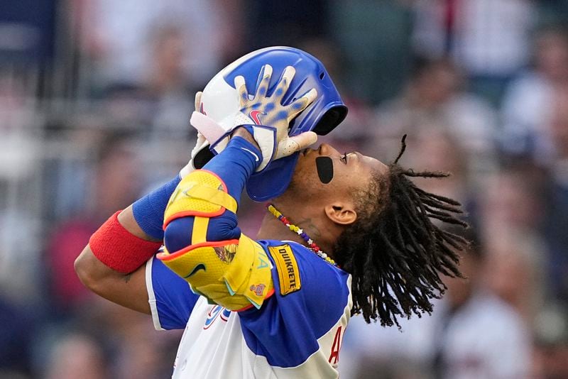 Atlanta Braves right fielder Ronald Acuna Jr. (13) puts on a helmet in the first inning of a baseball game against the Pittsburgh Pirates, Saturday, Sept. 9, 2023, in Atlanta. (AP Photo/Brynn Anderson)
