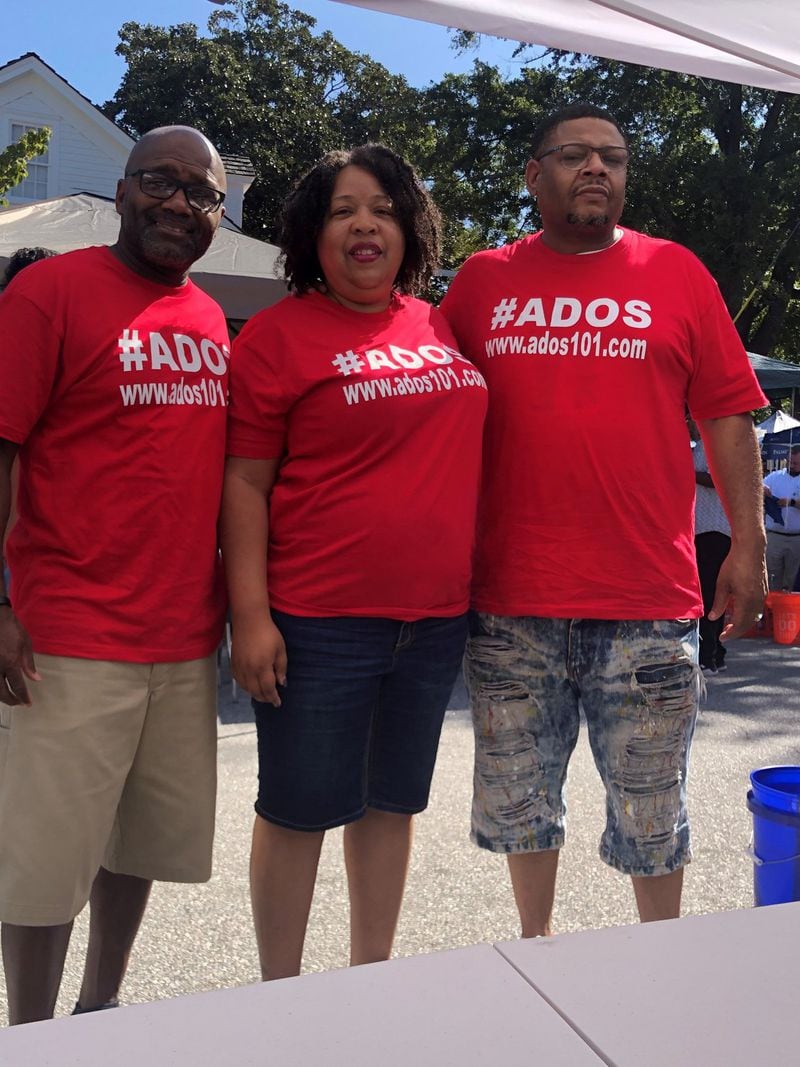 Amirah Lawson (center), with her husband Theodore Lawson (right) and Michael Adams, members of ADOS. CONTRIBUTED