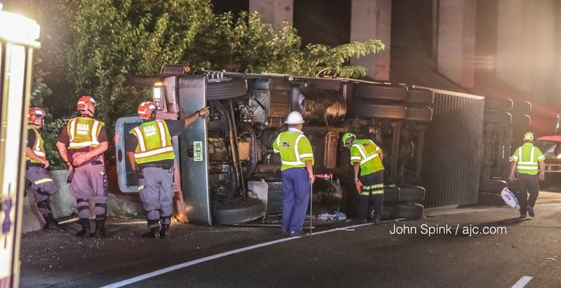 All lanes of I-285 East were shut down at the ramp to I-75 North after a tractor-trailer hauling cattle overturned. JOHN SPINK / JSPINK@AJC.COM