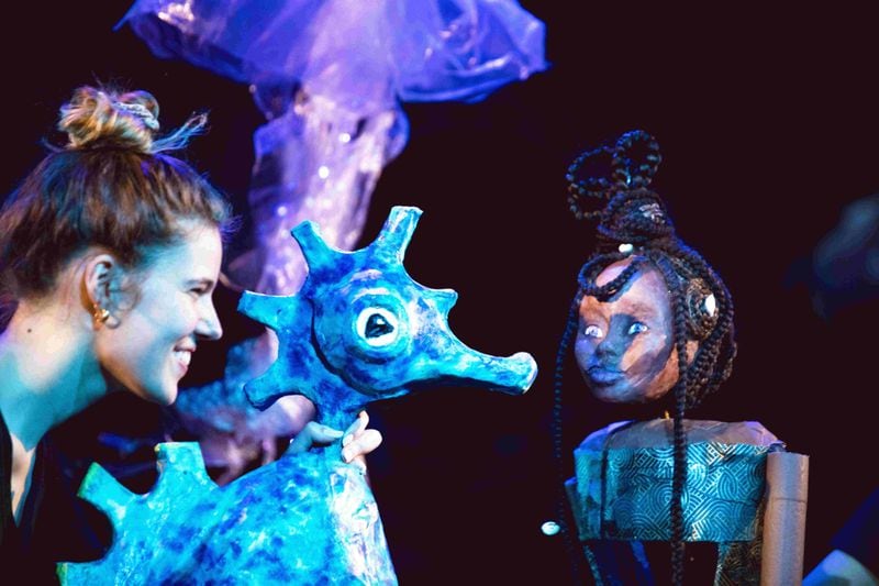 Actress Rebekah Babelay works with seahorse and human puppet in a performance of "Human." Courtesy of Stephan Pruitt
