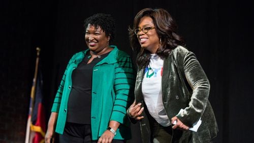 Oprah Winfrey, right, and Georgia Democratic gubernatorial candidate Stacey Abrams greet the audience during a town hall style event at the Cobb Civic Center in Marietta in November 2018. Winfrey will join up with Abrams again for a virtual campaign event Thursday.