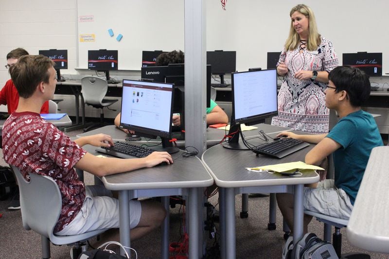 8/5/18 - Norcross - Beckie Mae, a teacher at Paul Duke STEM High School, helps her students login to their computers in an AP computer science class during their first day at school on Monday, August 6. Jenna Eason / Jenna.Eason@coxinc.com