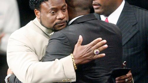 Bishop Eddie Long (L) embraces a friend at the New Birth Missionary Baptist Church . The Lithonia megachurch pastor died at 63. (Photo by John Amis-Pool/Getty Images)