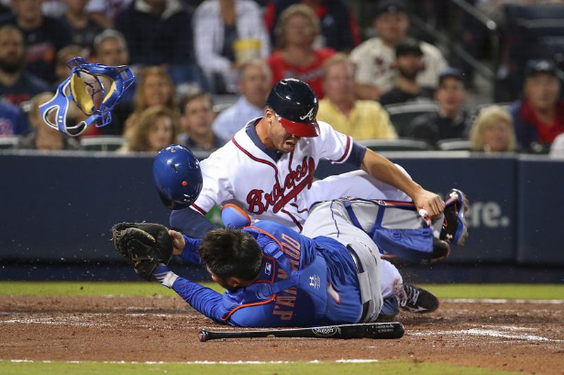 Atlanta Braves' Andrelton Simmons collides with New York Mets catcher Travis d'Arnaud at home plate in the second inning of a baseball game Friday, April 10, 2015, in Atlanta. Simmons was out on the play. (AP Photo/Kevin Liles) Shockin' the world, joltin' the Mets. (AP Photo/Kevin Liles)