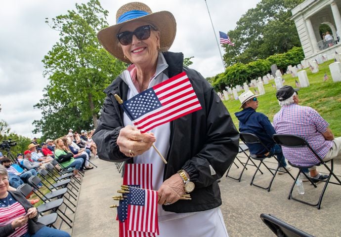 Paula Alexander of Marietta passes out flags at the 77th annual Memorial Day Observance at the Marietta National Cemetery on Monday, May 29, 2003.  (Jenni Girtman for The Atlanta Journal-Constitution)