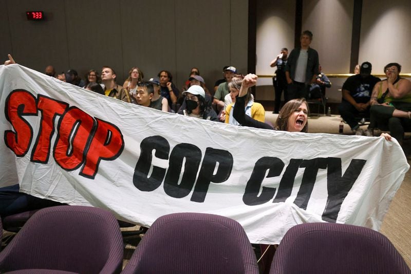 Protestors hold a banner and shout, "Stop Cop City," during the public comment portion of the Atlanta City Council ahead of the final vote to approve legislation to fund the training center at Atlanta City Hall, on June 5, 2023, in Atlanta. (Jason Getz/The Atlanta Journal-Constitution/TNS)