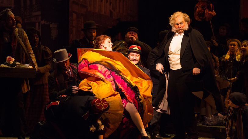 Leah Partridge as Musetta and Alan Higgs as Alcindoro appear in a scene from the carnival-like Latin Quarter in the 2015 production of “La Boheme” by the Atlanta Opera. The Atlanta company will present a revival of that production as part of the 2020-2021 season. CONTRIBUTED: JEFF ROFFMAN