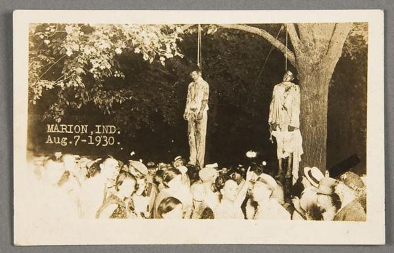  A picture on the front page of an Indiana newspaper in 1930 showed the lynching of two men. The newspaper photo became the postcard shown here.