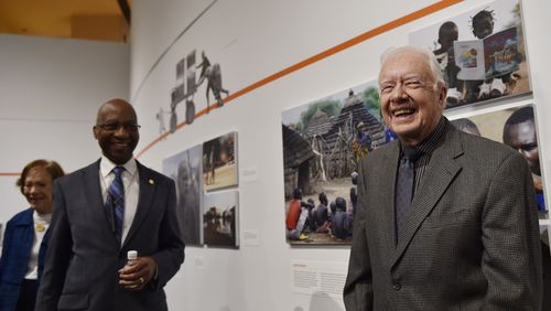 In this 2017 photo,- former President Jimmy Carter, right, Dr. Donald Hopkins, center, and Rosalynn Carter, far left, give a tour of an exhibition on disease eradication at the Jimmy Carter Presidential Library and Museum in Atlanta. The Carter Center has aided in the near extinction of Guinea worm disease.  (DAVID BARNES / DAVID.BARNES@AJC.COM)
