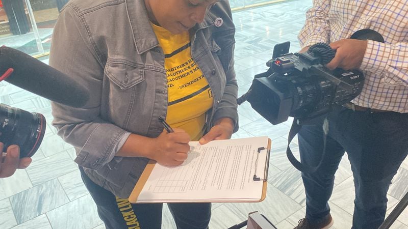 Organizer Mary Hooks becomes the first person to sign the petition for a referendum on the planned public safety training center. The group has to collect more than 70,000 for it to be on the November ballot.