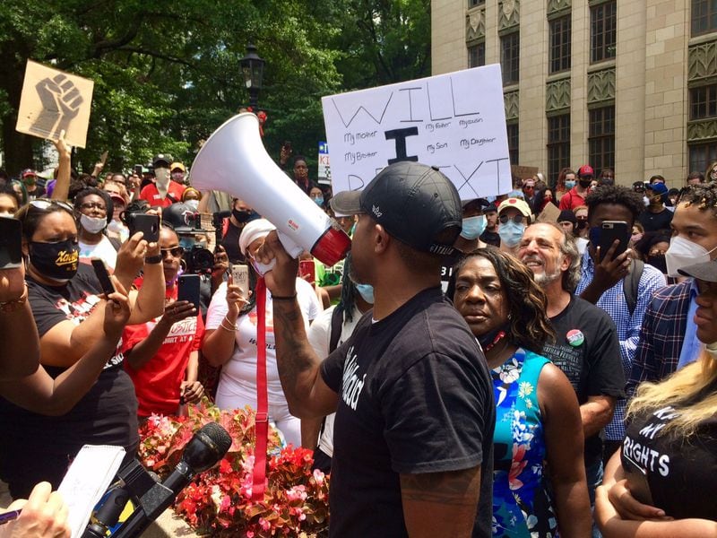 Marcus Coleman, an organizer of protest marches in Atlanta, speaks to a crowd outside City Hall. (Photo by Bill Torpy)