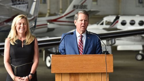 Gov. Brian Kemp, with first lady Marty Kemp, speaks Wednesday at DeKalb-Peachtree Airport as he starts a statewide tour to mark his first 100 days as Georgia’s 83rd governor. HYOSUB SHIN / HSHIN@AJC.COM