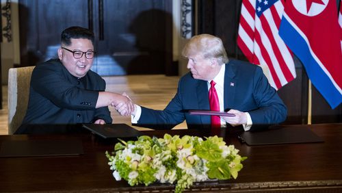 President Donald Trump and Kim Jong Un of North Korea during a document signing ceremony on Sentosa Island in Singapore, June 12, 2018. Since their meeting, a new propaganda film released in North Korea shows Kim as a global leader on an equal footing with Trump.
