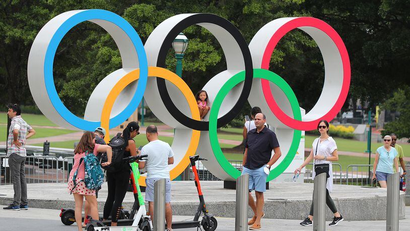 080221 Atlanta: Visitors to Centennial Olympic Park take in the Olympic rings on Monday, August 2, 2021, in Atlanta.   “Curtis Compton / Curtis.Compton@ajc.com”