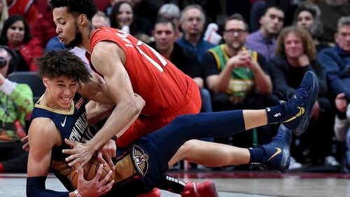 New Orleans Pelicans center Jaxson Hayes, left, and Portland Trail Blazers forward Skal Labissiere, right, scramble for a ball during the second half of an NBA basketball game in Portland, Ore., Monday, Dec. 23, 2019. The Pelicans won 102-94. (AP Photo/Steve Dykes)