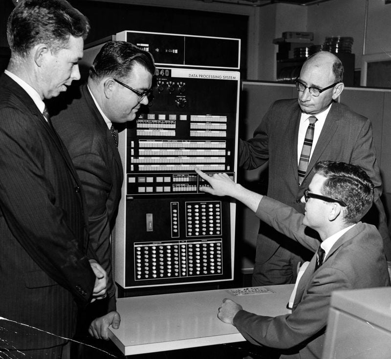 Visiting school officials Reid Gillis, from left, George Woodruff, William Wells and Gordon Howell, seated, check Georgia State University’s computer on Aug 21, 1966. Photo: Robert Connell