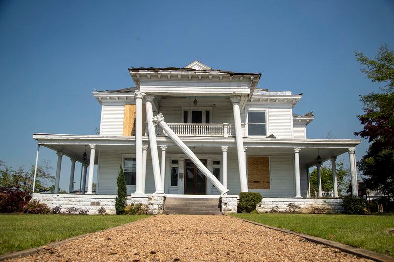 Some of Newnan's historic homes suffered damage from the strong winds, including this home with toppled Ionic columns. (Alyssa Pointer / Alyssa.Pointer@ajc.com)