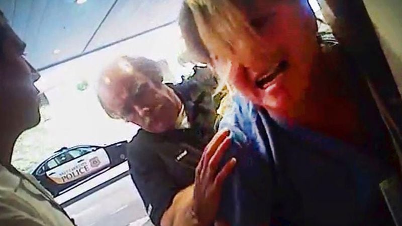 FILE - In this July 26, 2017, frame grab from video taken from a police body camera and provided by attorney Karra Porter, nurse Alex Wubbels is arrested by a Salt Lake City police officer at University Hospital in Salt Lake City. Utah Police Detective Jeff Payne was fired Tuesday, Oct. 10, 2017, in a case that became a flashpoint in the ongoing national conversation about police use of force. (Salt Lake City Police Department/Courtesy of Karra Porter via AP, File)