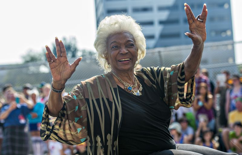 LIVING LONG AND PROSPERING--September 5, 2015 Atlanta - Nichelle Nichols, who played communications officer Lieutenant Uhura aboard the USS Enterprise in the popular Star Trek television series and succeeding motion pictures, gives the Vulcan symbol of live long and prosper as she rides down Peachtree St. during the annual DragonCon Parade in Atlanta on Saturday, September 5, 2015. JONATHAN PHILLIPS / SPECIAL