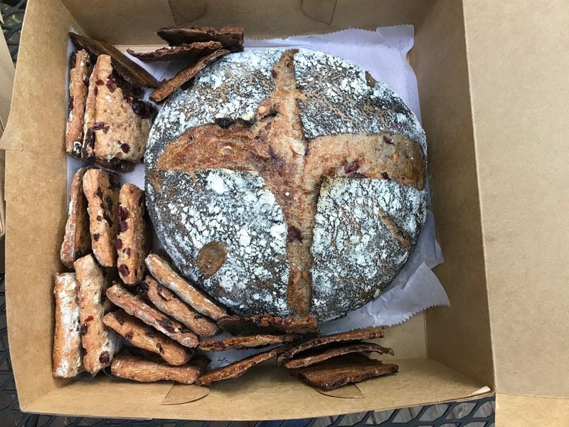 Abigail Cole’s sourdough bread is substantial and chewy. This loaf is packaged with an assortment of cranberry crackers. BO EMERSON/BEMERSON@AJC.COM