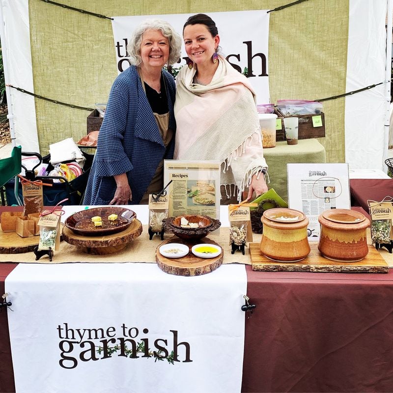 Becky Battle (left) and Lindsey Conway of Thyme to Garnish sell their herb-and-spice mixes at neighborhood events, such as the recent Candler Park Fall Festival. CONTRIBUTED BY THYME TO GARNISH
