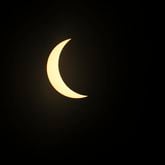 At 3:09 p.m. the solar eclipse goes to maximum eclipse during the practice round of the 2024 Masters Tournament at Augusta National Golf Club, Monday. (Jason Getz / jason.getz@ajc.com)