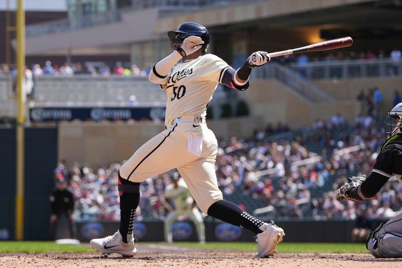 Minnesota Twins' Willi Castro (50) hits an RBI-single during the sixth inning of a baseball game against the Chicago White Sox, Thursday, April 25, 2024, in Minneapolis. (AP Photo/Abbie Parr)