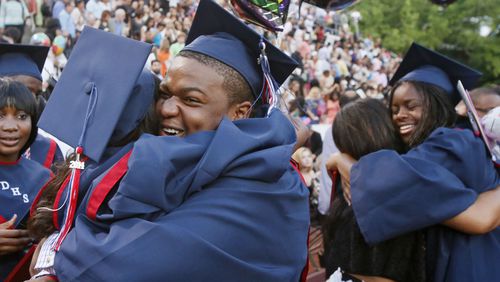 Dunwoody High School graduates celebrate after a ceremony in Chamblee. (BOB ANDRES / BANDRES@AJC.COM)