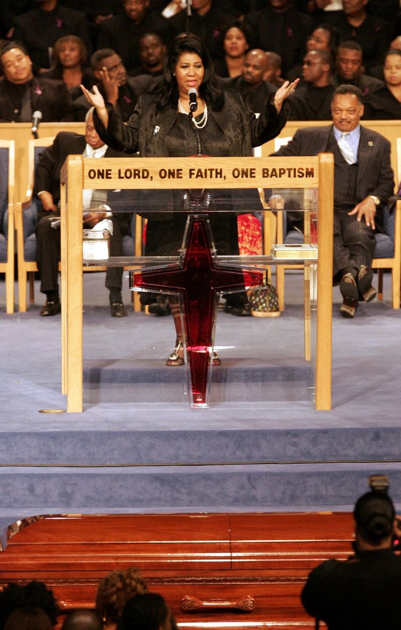 Aretha Franklin sings during the funeral service for civil rights icon Rosa Parks at the Greater Grace Temple in Detroit on Nov. 2, 2005. Parks, whose refusal to give up her bus seat to a white man sparked the modern civil rights movement, died on Oct. 24, 2005, at the age of 92. (AP Photo/Carlos Osorio)