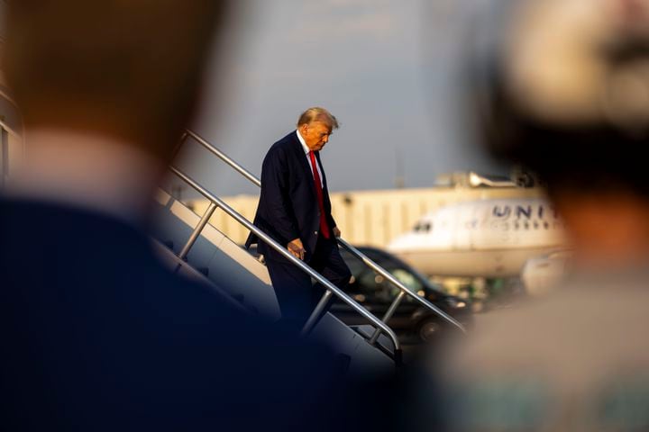 Donald Trump exits his private plane after arriving at Hartsfield-Jackson International Airport in Atlanta on Thursday, Aug. 24, 2023, where he was expected to turn himself in at the Fulton County Jail later in the evening. (Doug Mills/The New York Times)